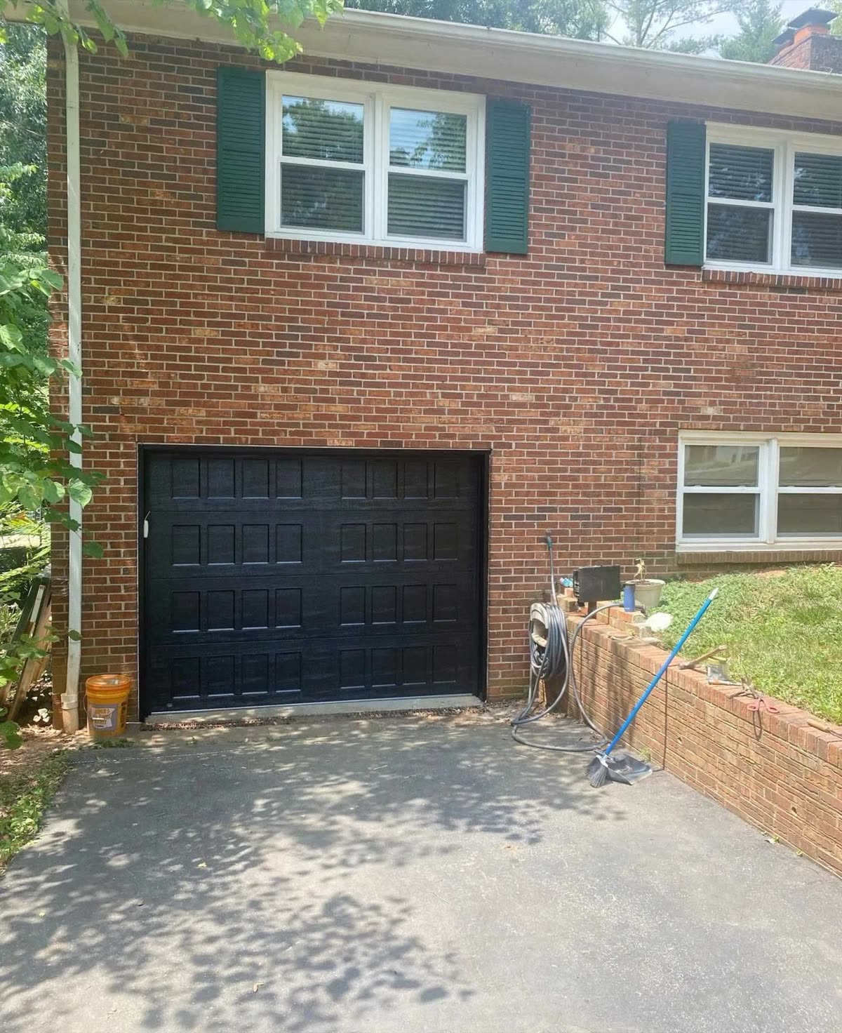 New black garage door on a brick home near Clemmons NC